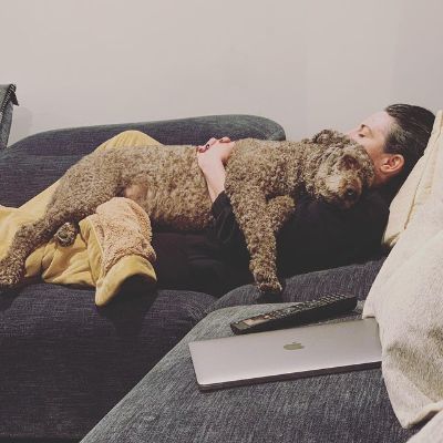 Armine Shamiryan is sleeping in the couch cuddling Angelo.